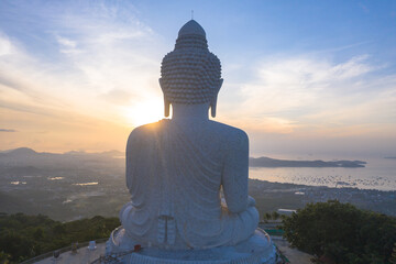 aerial view glare of sunrise on the shoulder of Phuket big Buddha.Phuket Big Buddha is one of the island most important and revered landmarks on the island..image for travel and culture concept.. © Narong Niemhom