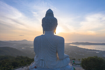 aerial view glare of sunrise on the shoulder of Phuket big Buddha.Phuket Big Buddha is one of the island most important and revered landmarks on the island..image for travel and culture concept.. © Narong Niemhom