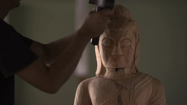 Full HD, Asia craftsman professional use chisel craving wood handmade buddha statue in workshop. Artist engrave wood. Carpentry woodwork. Handcraft carved. Selective focus.