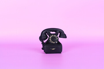 old phone isolated on pink background 
