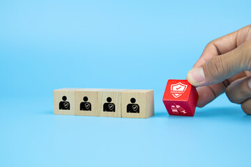 Hand choose cube wooden block stack and immunity protect icon with Covid-19 vaccine needle syringe and people in a protected society for prevent and safety for medical and health concept.