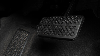 Man foot and accelerator and brake pedal inside the car or vehicle and copy space which black color...