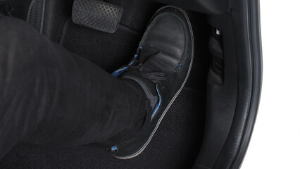 Man foot and accelerator and brake pedal inside the car or vehicle and copy space which black color...