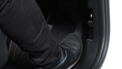 Man foot and accelerator and brake pedal inside the car or vehicle and copy space which black color...