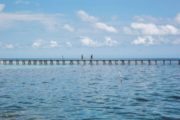People Walking on the wooden bridge in the middle of ocean at Karimun Jawa