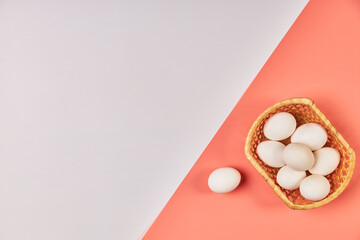 Eggs for Easter in a basket pink white background