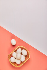 Eggs for Easter in a basket pink white background