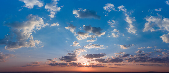 Cancer blue stormy sky with sun rays.