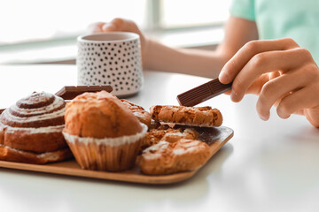 Young man eating sweets at home, closeup