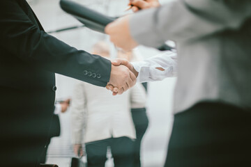 close up. business woman meeting a colleague with a handshake.