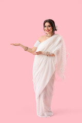 Beautiful Indian woman on color background