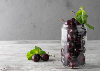 Ripe, juicy cherries in a transparent glass glass close-up