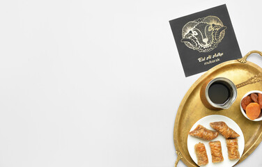 Greeting card for Eid al-Adha (Feast of the Sacrifice) with Turkish coffee and sweets on light background