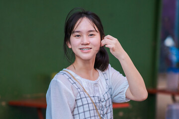 Portrait of teenager girl happy walking on city streets, 