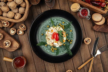 Restaurant garnished russian olivier salad on wooden background