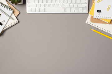 Top view photo of workstation white keyboard stationery notebooks binder clips yellow pencil pen...
