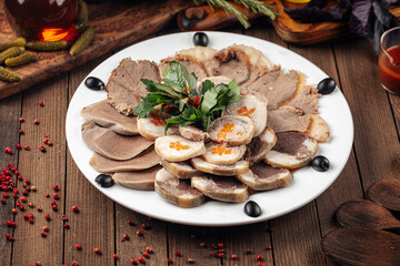 Plate of kazakh appetizer horse meat kazy platter on wooden background