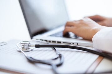 Medical stethoscope left in the doctor office in hospital close up with copy space.