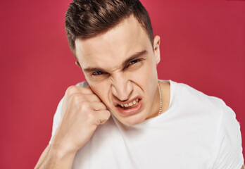 angry man in white t-shirt emotions irritable look close-up