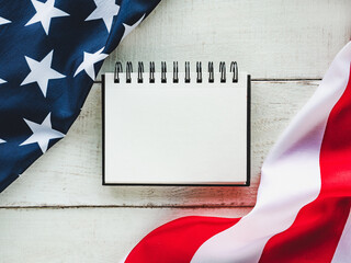Fototapeta na wymiar American Flag lying on an empty table. Place for your inscription. Beautiful card. Closeup, view from above. National holiday concept. Congratulations for family, relatives, friends and colleagues