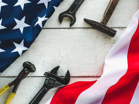 LABOR DAY. Hand Tools And The Flag Of The United States Of America Lying On The Table. View From Above, Close-up. Congratulations To Family, Relatives, Friends And Colleagues. National Holiday Concept