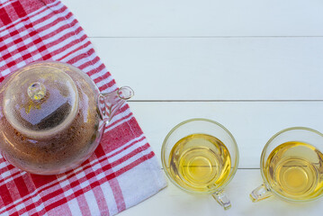 flat lay of cups of green and chinese tea on white table