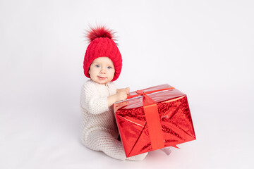 the kid with the red hat and gift on white isolated background, space for text, concept of new year and Christmas