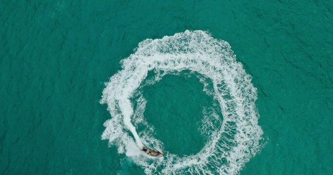 Epic jet ski ride, adventurous young couple playing on jet ski in tropical blue ocean, vacation adventure lifestyle