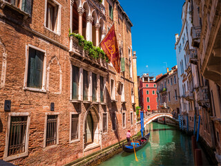 Fototapeta na wymiar Venice tight water streets with popular gondola transportation