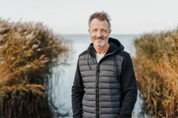 Tousled natural middle-aged man enjoying a day at the seaside