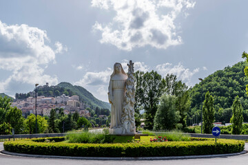 The statue of Santa Rita da Cascia welcomes the faithful at the entrance of the town, Cascia, Italy