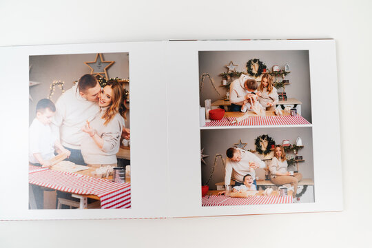 pages of photobook from a family photo shoot in kitchen