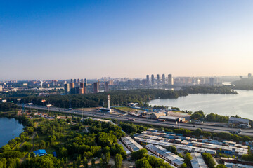 panoramic view of a green residential area near the lake filmed from a drone 