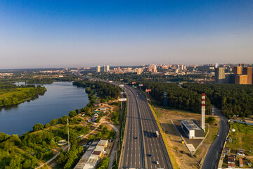 Fototapeta na wymiar panoramic view of the motorway junction and fast moving cars filmed from a drone 