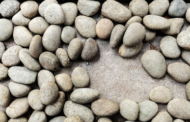 Small round rock or stone background with one empty space spot on the ground