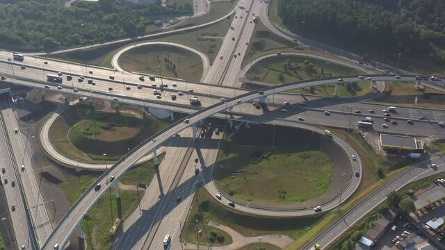 panoramic view of the motorway junction and fast moving cars filmed from a drone 