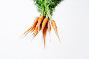 Fresh small carrots isolated on white background, close-up view.