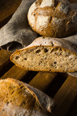 homemade bread over wooden cutting board. top view wooden background. detail