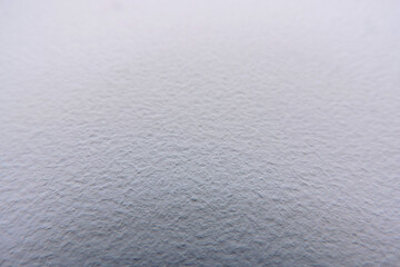 A close-up of a white painted wall surface