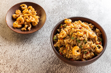 Shrimp dish. Paella with shrimps. Spanish dish with shrimps. Serving in clay bowls.