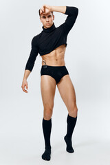 man in full growth, inflated torso bodybuilder fitness underpants and black sweater 