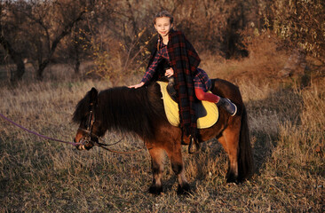  girl with little horse in the forest

