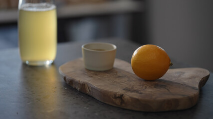 Sweet lemon on olive wood board part of serving for crab legs