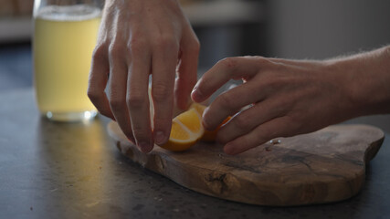 Man making dip sauce for crab legs on olive wood board