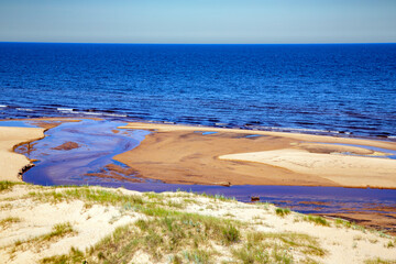 The small freshwater Peterupe river flows into the Baltic Sea near the White Dune in Saulkrasti, Latvia	
