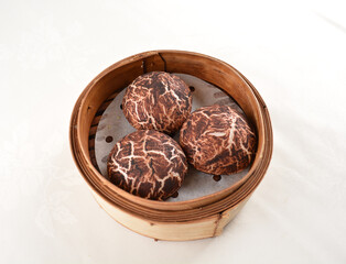 steamed cheesy truffle chicken bun bread in mushroom design in bamboo basket Hong Kong dim sum snack menu
