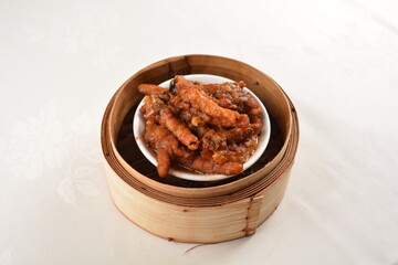 steamed chinese marinated chicken claw feet in bamboo basket Hong Kong dim sum snack menu