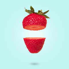 Floating levitating ripe strawberry on a blue background.