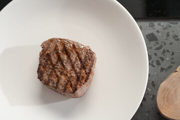 Whole beef steak on white plate