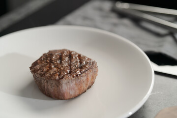 Whole beef steak on white plate